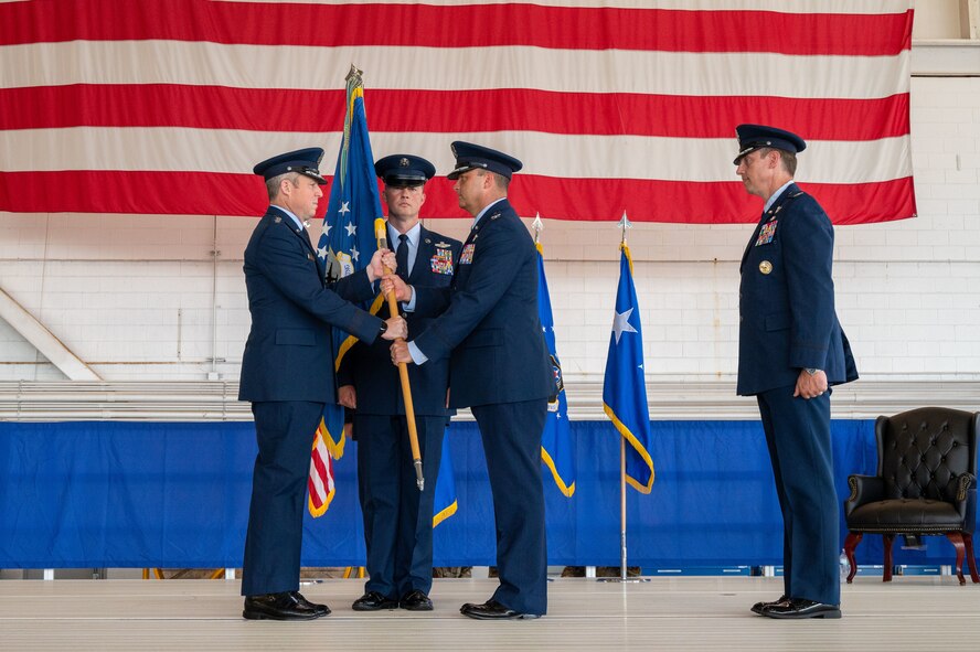 U.S. Air Force Lt. Gen. Michael Conley, commander Air Force Special Operations Command, passes the guidon to Col. Zach Blom, incoming commander of the 492nd SOW, during a change of command ceremony at Hurlburt Field, Florida, June 27, 2025.