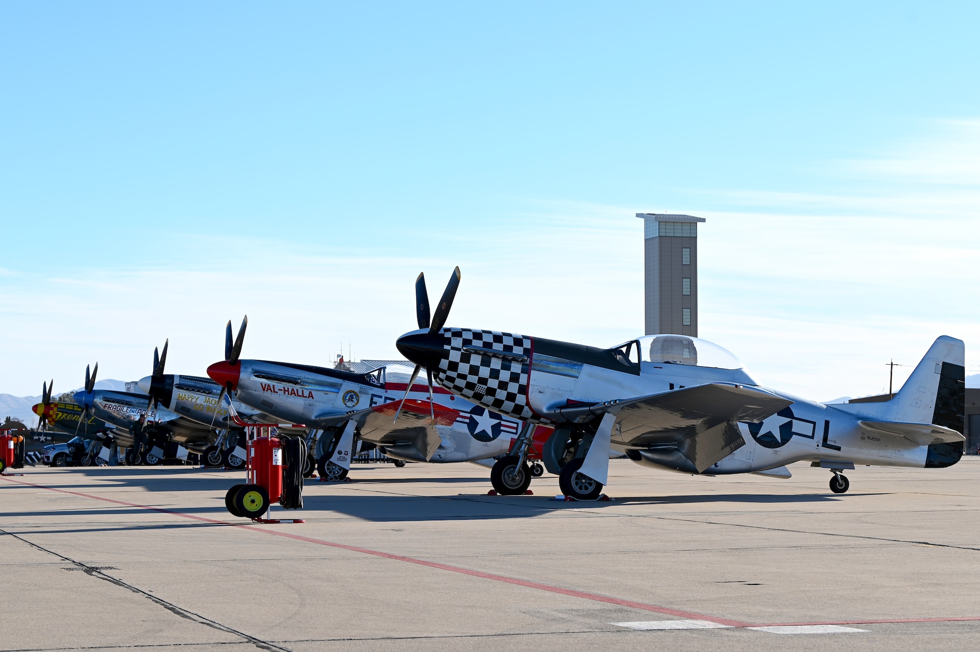 Four P-51 Mustang aircraft rest on the flightline in the morning before Heritage Flight Training Course begins at Davis-Monthan Air Force Base, Arizona, March 1, 2025. The P-51 Mustang was used as an American long-range fighter-bomber in World War II and the Korean War. (U.S. Air Force photo by Senior Airman Andrew Garavito)
