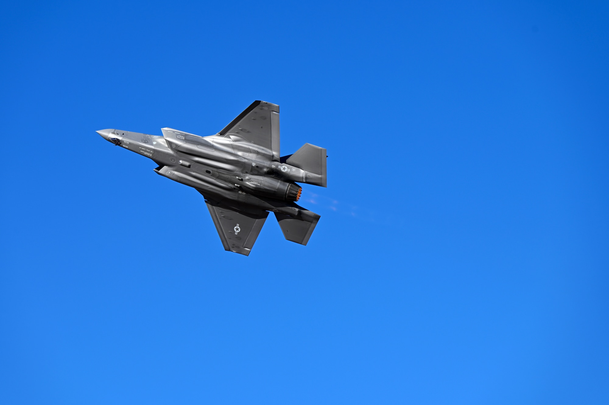 A U.S. Air Force F-35A Lightning II aircraft showcases its agile flight maneuvers in an aerial demonstration during Heritage Flight Training Course at Davis-Monthan Air Force Base, Arizona, March 1, 2025. The F-35A provides next-generation stealth, enhanced situational awareness and reduced vulnerability for the United States and allied nations. (U.S. Air Force photo by Senior Airman Andrew Garavito)