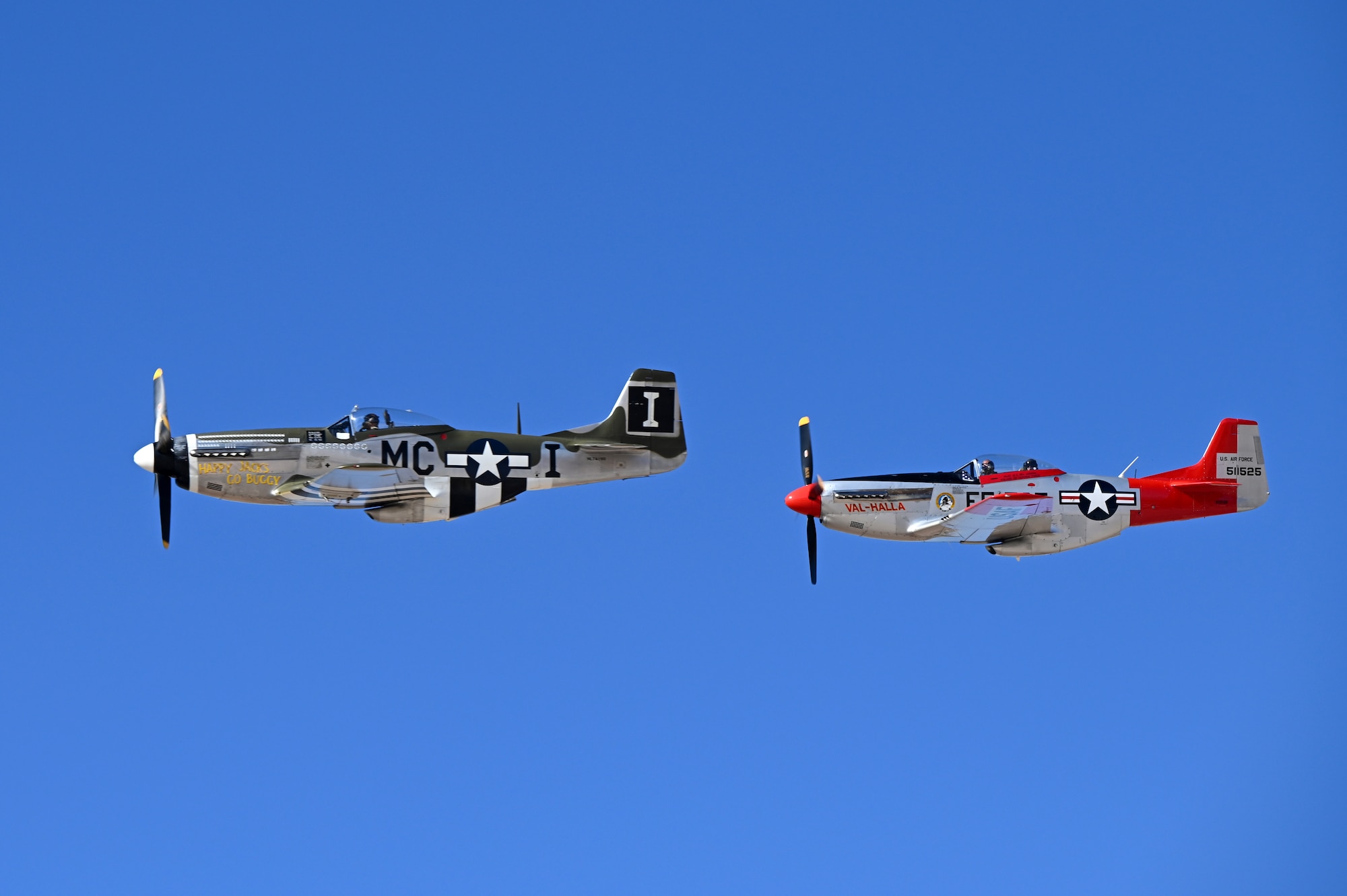 Two P-51 Mustang aircraft perform the second flight of the day as a two-man aerial demonstration during Heritage Flight Training Course at Davis-Monthan Air Force Base, Arizona, March 1, 2025. The P-51 Mustang was used as an American long-range fighter-bomber in World War II and the Korean War. (U.S. Air Force photo by Senior Airman Andrew Garavito)