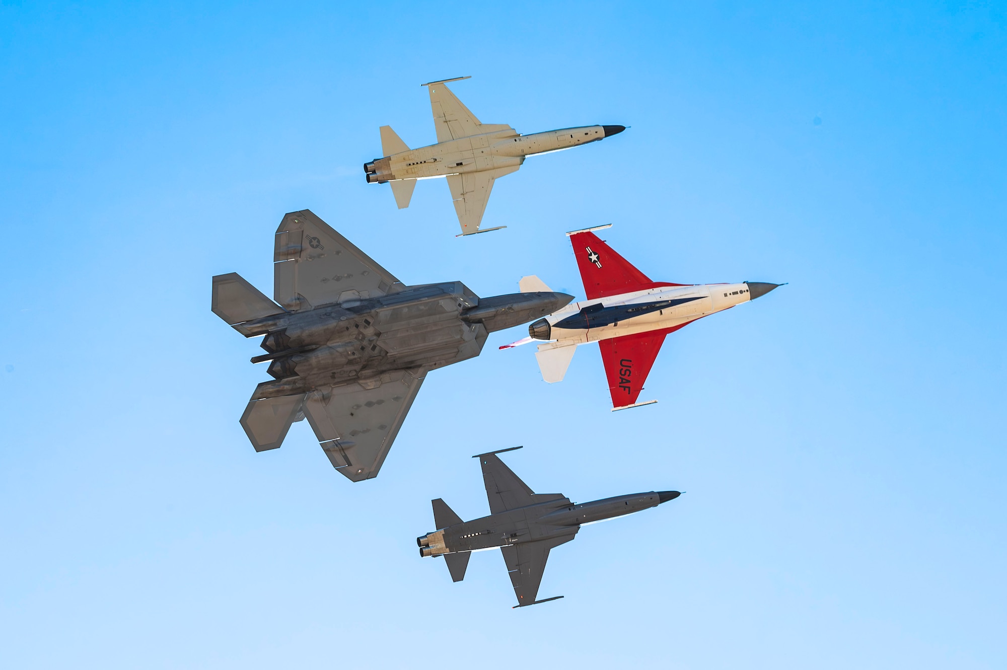 A U.S. Air Force F-22 Raptor aircraft, F-5 Northrop aircraft and F-16 Fighting Falcon aircraft soar overhead during Heritage Flight Training Course at Davis-Monthan Air Force Base, Arizona, Mar. 1, 2025. Heritage Flights reflected the milestones in the development of U.S. air combat forces over time. (U.S. Air Force photo by Airman Samantha Melecio)