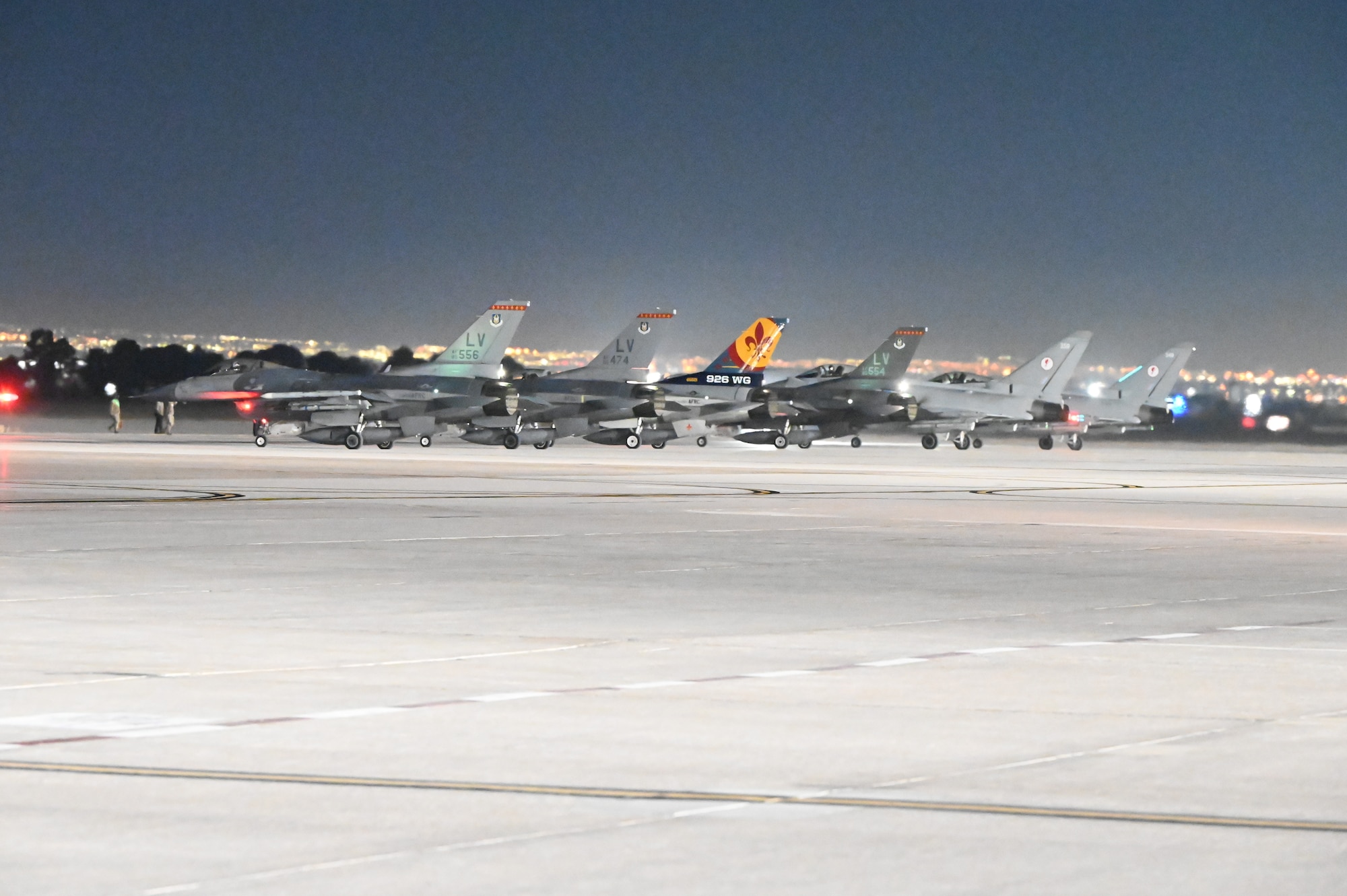 Fighter jets line up on the flight line before takeoff during Red Flag 25-1.