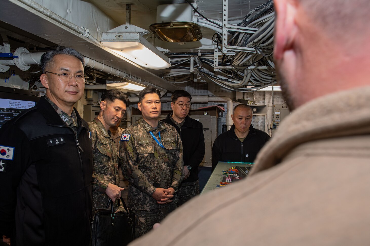 250301-N-GC571-1082 AT SEA (March 1, 2025) From left, Republic of Korea Rear Adm. Kim Ji-Hoon, director, Maritime Operations Center; Cmdr. Park Jaehyun, training officer, Republic of Korea Fleet Command; Cmdr. Yoo Sang-Hoon, Republic of Korea Fleet Command; Capt. Kim Jin-Tae, Republic of Korea Fleet Command; and Cmdr. Jimmy Suh, operations plans and readiness, Commander, U.S. Naval Forces Korea, tour Flight Deck Control aboard the Nimitz-class aircraft carrier USS Carl Vinson (CVN 70), March 1, 2025. Vinson, the flagship of Carrier Strike Group ONE, is underway conducting routine operations in the U.S. 7th Fleet area of operations. (U.S. Navy photo by Mass Communication Specialist Seaman Apprentice Pablo Chavez)
