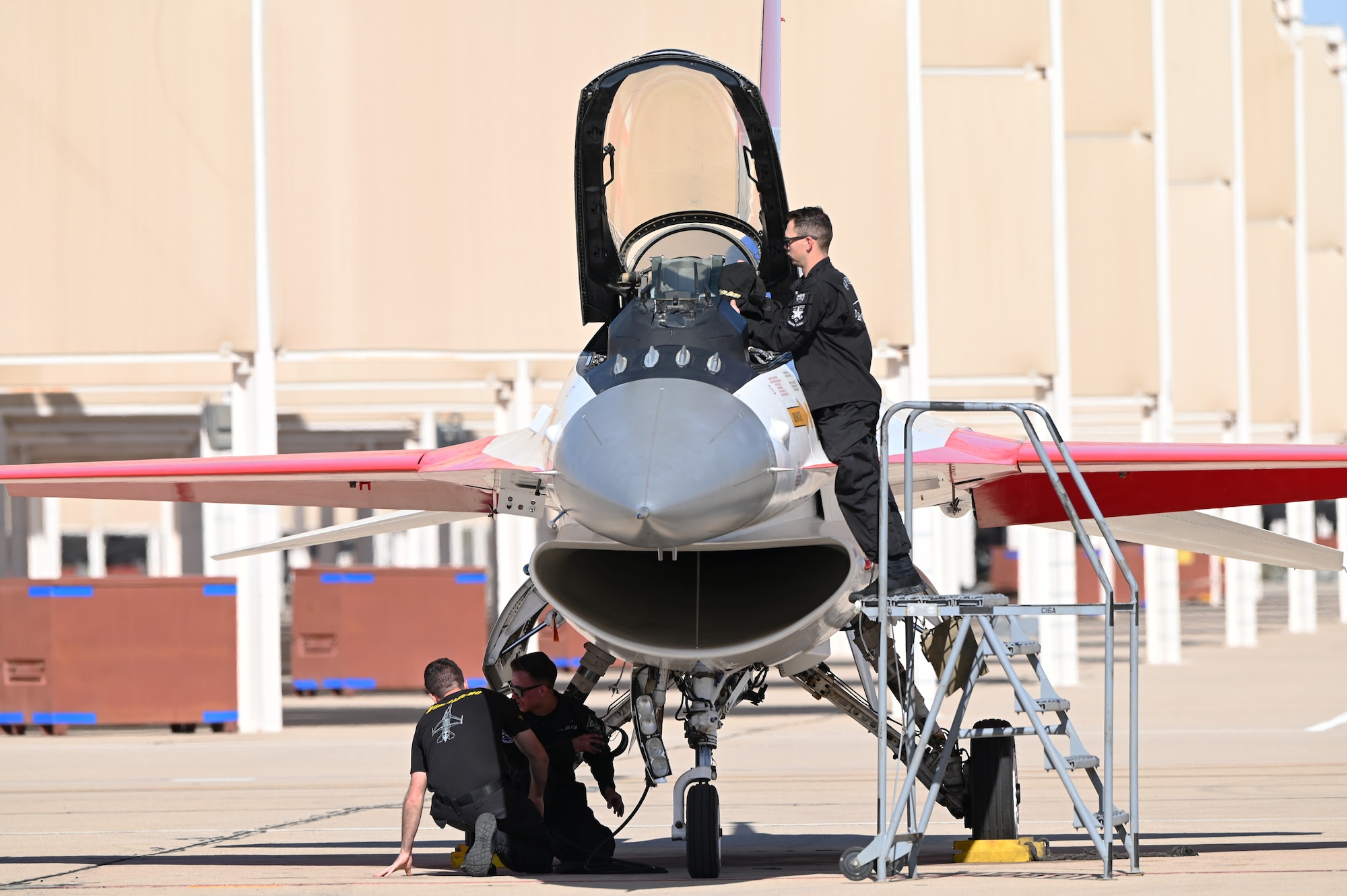 U.S. Air Force Airmen from the F-16 Viper demonstration team perform preflight checks during Heritage Flight Training Course at Davis-Monthan Air Force Base, Arizona, March 1, 2025. Heritage flights are flown with past and current U.S. Air Force aircraft to honor the past, present and future of American airpower. (U.S. Air Force photo by Senior Airman Andrew Garavito)