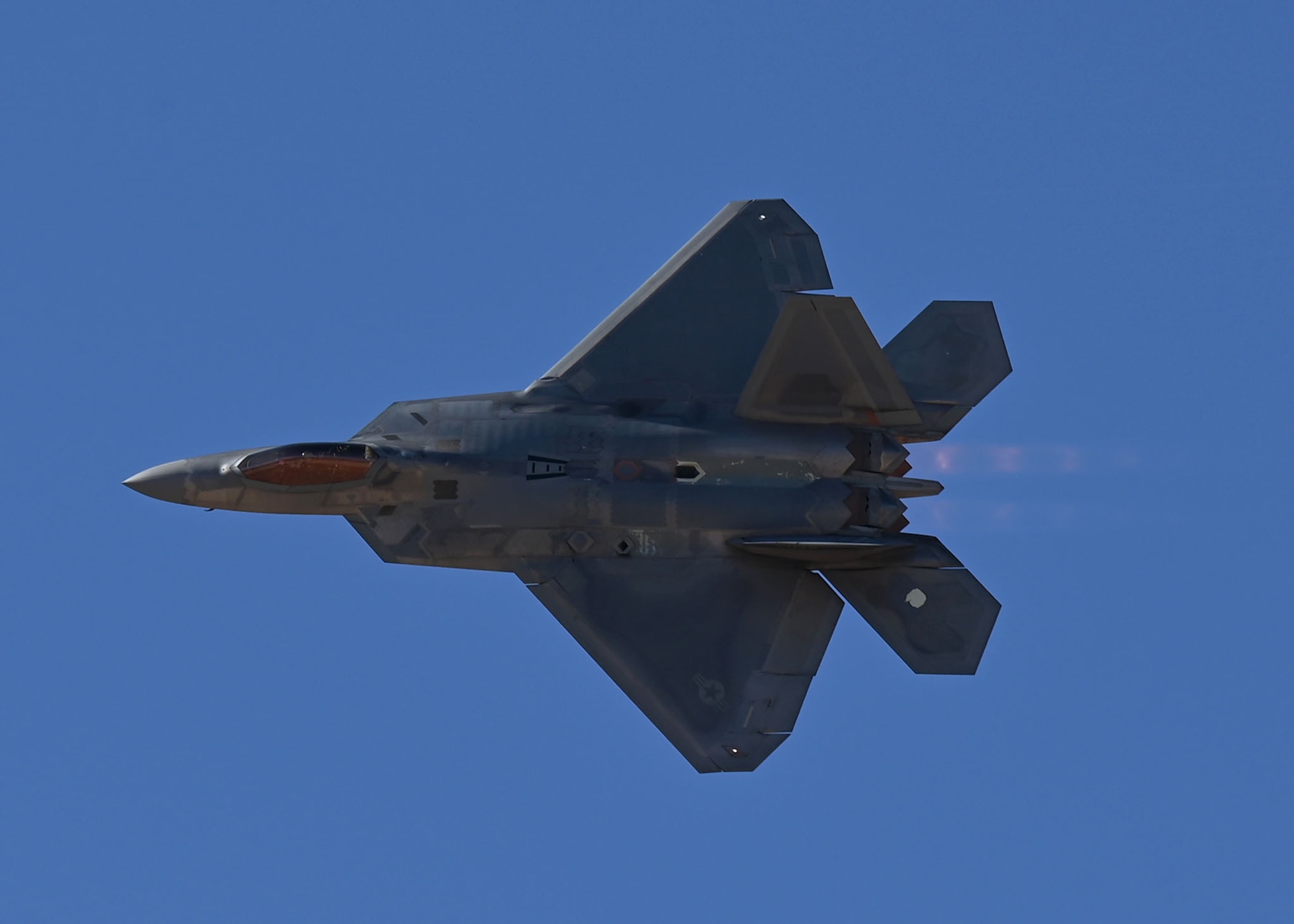 A U.S. Air Force F-22 Raptor aircraft demonstrates aerial capabilities at the Heritage Flight Training Course at Davis-Monthan Air Force Base, Arizona, March 1, 2025. The Air Combat Command F-22 Raptor Demonstration Team performs precision aerial maneuvers to demonstrate the unique capabilities of the fifth-generation fighter aircraft. (U.S. Air Force photo by Staff Sgt. Abbey Rieves)