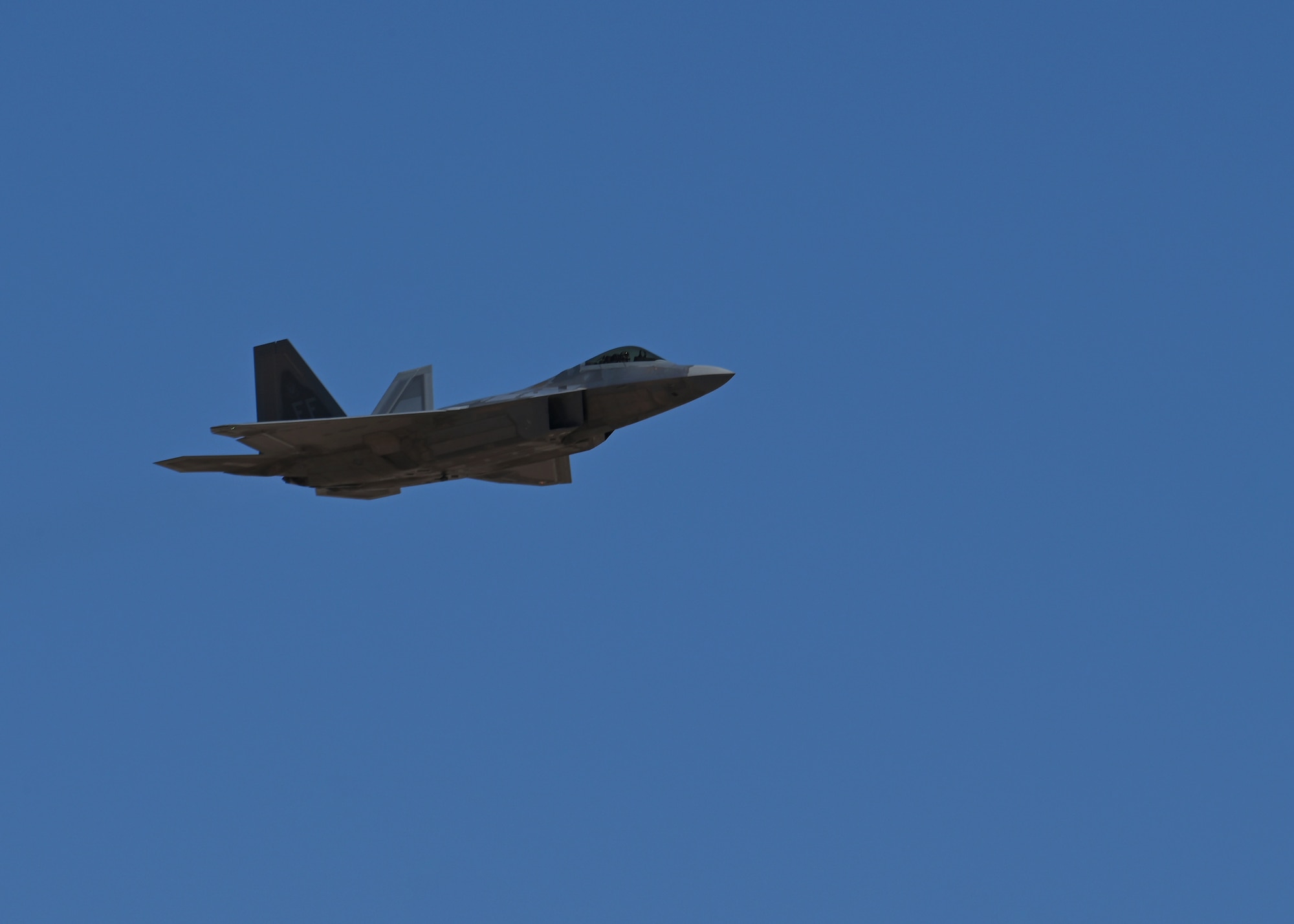 A U.S. Air Force F-22 Raptor aircraft trains at the Heritage Flight Training Course at Davis-Monthan Air Force Base, Arizona, March 2, 2025. This training reinforces the lethality and readiness of today’s Air Force, ensuring its ability to rapidly employ combat power. (U.S. Air Force photo by Staff Sgt. Abbey Rieves)