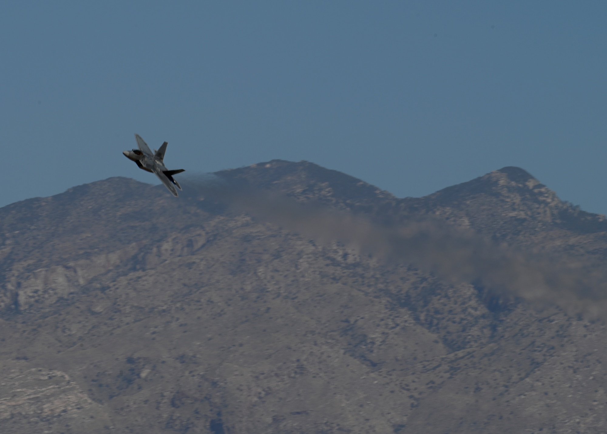 A U.S. Air Force F-22 Raptor aircraft circles back during the Heritage Flight Training Course at Davis-Monthan Air Force Base, Arizona, March 2, 2025. The HFTC showcases Air Power and military capabilities while certifying Air Combat Command Demonstration Teams for the 2025 airshow season. (U.S. Air Force photo by Staff Sgt. Abbey Rieves)