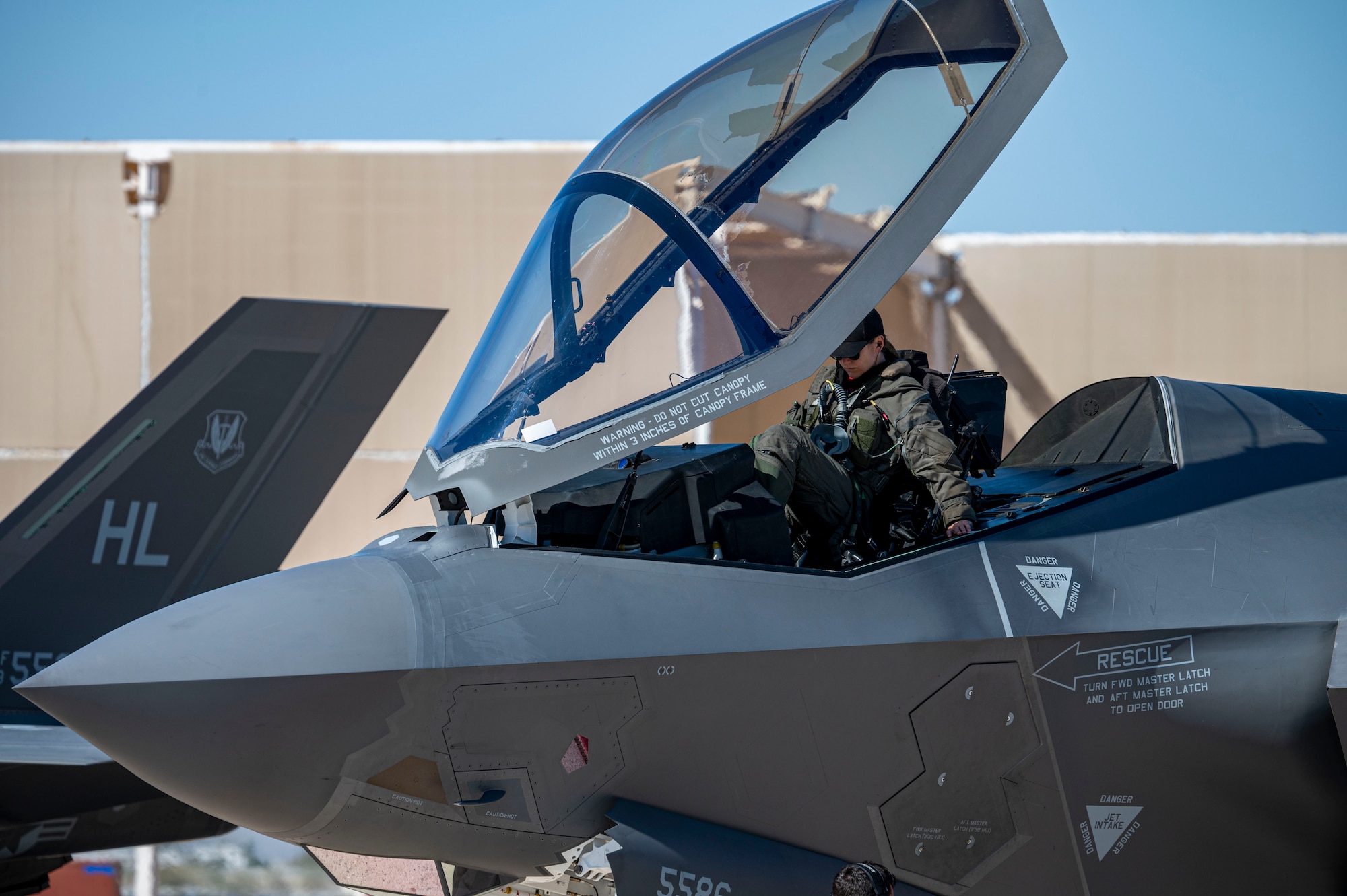 U.S. Air Force Maj. Melanie “MACH” Kluesner, F-35A Lightning II Demonstration Team commander and pilot, prepares to exit a U.S. Air Force F-35A at Davis-Monthan Air Force Base, Ariz., Arizona, March 2, 2025. Kluesner provides operational oversight and direction for the 13-personnel team, to include maintenance, aircrew flight equipment, and public affairs Airmen. (U.S. Air Force photo by Airman Samantha Melecio)