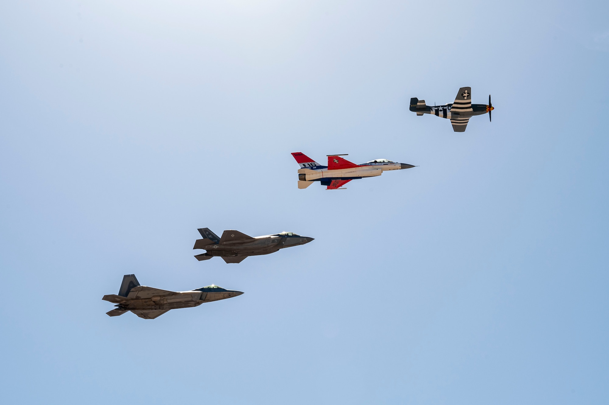 U.S. Air Force F-35A Lightning II, F-22 Raptor, F-16 Fighting Falcon and P-51 Mustang aircraft fly in formation during the Heritage Flight Training Course at Davis-Monthan Air Force Base, Arizona, March 2, 2025. The Air Combat Command demonstration teams work closely with the Air Force Heritage Flight Foundation to create a unique demonstration for the U.S. Air Force past and present, exhibiting the professional qualities the Air Force develops in the people who fly, maintain, and support these aircraft. (U.S. Air Force photo by Airman Samantha Melecio)