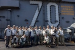 250301-N-TD381-2271 AT SEA (March 1, 2025) Distinguished visitors from U.S. Forces Korea, Commander, U.S. Naval Forces Korea, and the Republic of Korea Navy join together with leadership from the Nimitz-class aircraft carrier USS Carl Vinson (CVN 70), Carrier Air Wing 2, and Carrier Strike Group 1 on Vinson’s flight deck, March 1, 2025. Vinson, the flagship of Carrier Strike Group ONE, is underway conducting routine operations in the U.S. 7th Fleet area of operations. (U.S. Navy photo by Mass Communication Specialist 2nd Class Isaiah B. Goessl)