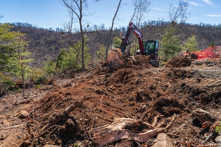 Crews work to remove vegetative debris from private property in Weaverville, North Carolina, Feb. 26, 2025.