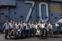 250301-N-TD381-2271 AT SEA (March 1, 2025) Distinguished visitors from U.S. Forces Korea, Commander, U.S. Naval Forces Korea, and the Republic of Korea Navy join together with leadership from the Nimitz-class aircraft carrier USS Carl Vinson (CVN 70), Carrier Air Wing 2, and Carrier Strike Group 1 on Vinson’s flight deck, March 1, 2025. Vinson, the flagship of Carrier Strike Group ONE, is underway conducting routine operations in the U.S. 7th Fleet area of operations. (U.S. Navy photo by Mass Communication Specialist 2nd Class Isaiah B. Goessl)