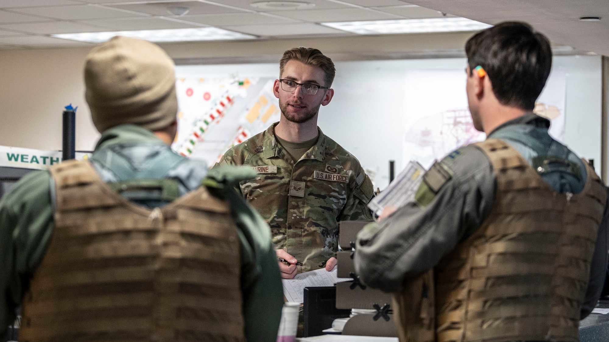 U.S. Air Force Senior Airman Zachary Saurine, center, 25th Fighter Squadron squadron aviation resource manager, conducts a pre-flight briefing for two A-10 Thunderbolt II pilots at Osan Air Base, Republic of Korea, Feb. 12, 2025. The pilots were participating in a combined arms live fire exercise with U.S. and ROK Army assets to enhance interoperability in close air support missions. (U.S. Air Force photo by Staff Sgt. Ashley N. Mikaio)