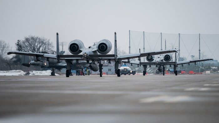 Two U.S. Air Force A-10 Thunderbolt IIs assigned to the 25th Fighter Squadron taxi down a runway at Osan Air Base, Republic of Korea, Feb. 12, 2025. The aircraft participated in a combined arms live fire exercise with U.S. and ROK Army assets, incorporating small arms, vehicle-mounted systems, indirect fire systems, and rotary and fixed-winged aircraft support to assess unit coordination and operational planning. (U.S. Air Force photo by Staff Sgt. Ashley N. Mikaio)