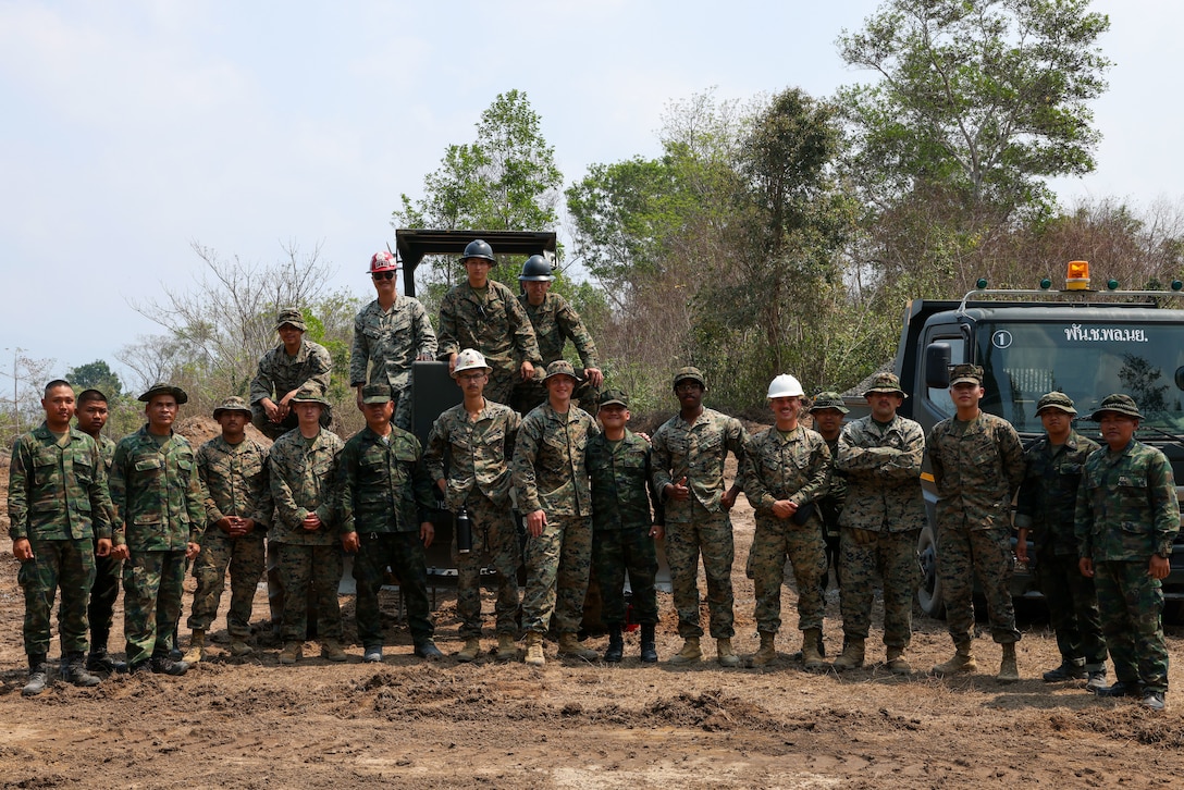U.S. Marines assigned to 9th Engineer Support Battalion, 3rd Marine Logistics Group, along with the Royal Thai Marine Corps, Construction Company of Combat Engineers pose for a photo road during Joint Exercise Cobra Gold 2025 at Ban Chan Khrem, Chanthaburi Province, Thailand, Feb. 20, 2025. The commitment of the U.S. to the region is demonstrated through the exercise, which builds interoperability, fosters multilateral cooperative arrangements, and shared common interests, all while reinforcing the dedication to allies and partners in ensuring a free and open Indo-Pacific region. (U.S. Army photo by Staff Sgt. Eve K. Moore, I Corps Public Affairs)