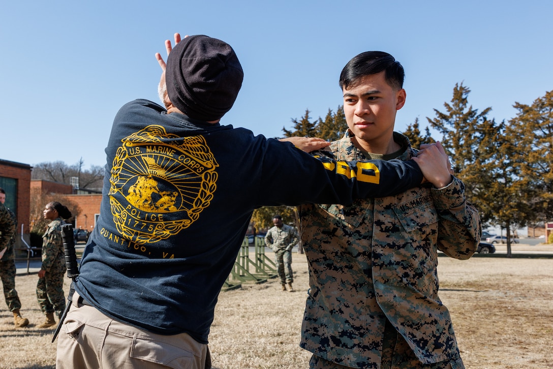 U.S Marine Corps Lance Cpl. Joaquin Dela Torre, a combat photographer with Security Battalion conduct defensive tactics during Security Augmentation Force training on Marine Corps Base Quantico, Virginia, Feb. 25, 2025. SAF provides Marines from other occupational specialties an opportunity to increase readiness and fulfill an additional billet which military police can utilize in case of emergencies. (U.S. Marine Corps photo by Lance Cpl. Braydon Rogers)