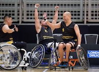 Carlos Valerio, right, high-fives a teammate during a wheelchair basketball match at the 2025 Invictus Games, held Feb. 8-16 in Vancouver and Whistler, Canada. As a member of Team U.S. for the second time, Valerio – a Navy veteran, Army civilian employee and gastric cancer survivor – competed in the biathlon and on a mixed-nation “Unconquered” team in basketball, earning a bronze medal. It was the first time an Unconquered team earned a medal at Invictus.