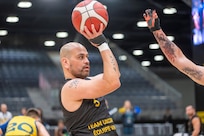 Carlos Valerio, a gastric cancer survivor, Navy veteran and current Army civilian at U.S. Army Medical Logistics Command, looks to shoot during a wheelchair basketball match during the 2025 Invictus Games, held Feb. 8-16 in Vancouver and Whistler, Canada. Valerio, a member of Team U.S., competed as part of a mixed-nation "Unconquered" team, winning a bronze medal in wheelchair basketball. It was the first time an Unconquered team has medaled in the event's 11-year history.