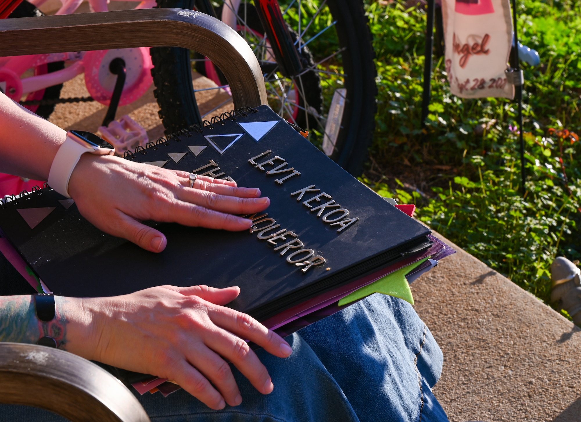 U.S. Air Force Tech. Sgt. Kathleen McConnell, Force Support Professional Development School master resilience trainer course instructor, holds on to the book of Levi Kekoa at Maxwell Air Force Base, Alabama Feb. 26, 2025.