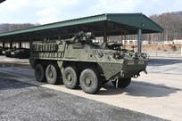 An upgraded double-V hull Stryker is moved from a storage yard to a maintenance bay at Fort Indiantown Gap, Pa., on Feb. 27, 2005. The 56th Stryker Brigade Combat Team is receiving 324 upgraded Strykers and 300 Joint Light Tactical Vehicles as part of a program to modernize the brigade. (Pennsylvania National Guard photo by Brad Rhen)