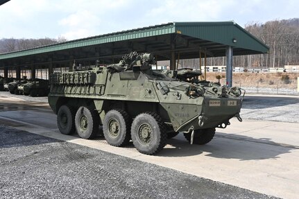 An upgraded double-V hull Stryker is moved from a storage yard to a maintenance bay at Fort Indiantown Gap, Pa., on Feb. 27, 2005. The 56th Stryker Brigade Combat Team is receiving 324 upgraded Strykers and 300 Joint Light Tactical Vehicles as part of a program to modernize the brigade. (Pennsylvania National Guard photo by Brad Rhen)