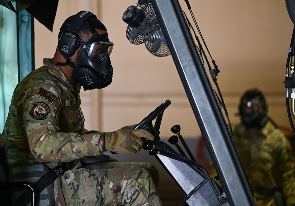 man in gas mask dives fork lift