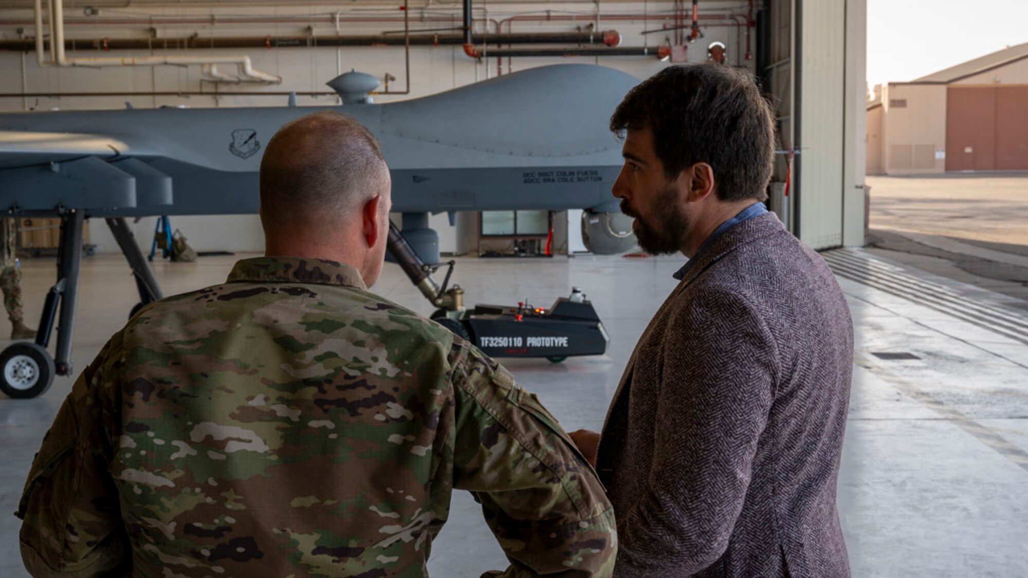 Alexander Kasinc, Evitado Technologies chief executive officer, right, conducts a towing demonstration to U.S. Air Force Col. Christopher Dunston, 49th Maintenance Group commander at Holloman Air Force Base, New Mexico, Feb. 27, 2025. Through a Phase II Small Business Innovation Research contract, the 49th Maintenance Group is working with Evitado Technologies and TowFLEXX Miltech to revolutionize aircraft towing with electric, remote-controlled tugs, while using advanced Light Detection and Ranging sensor technology to increase safety and efficiency, reduce manpower needs, and support sustainability goals for the Air Force. (U.S. Air Force photo by Senior Airman Isaiah Pedrazzini)