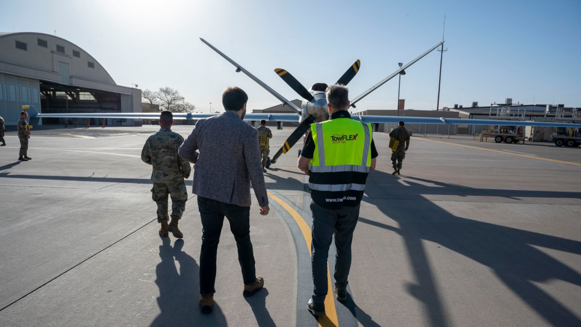 Members of Holloman, TowFLEXX Miltech and Evitado conduct an MQ-9 Reaper towing demonstration at Holloman Air Force Base, New Mexico, Feb. 27, 2025. The collaboration between the 49th Maintenance Group, Evitado Technologies, and TowFLEXX Miltech is to advance aircraft towing operations by integrating electric tugs with Light Detection and Ranging sensor collision detection, boosting safety, reducing costs, and supporting the U.S. Air Force’s sustainability and mission readiness objectives. (U.S. Air Force photo by Senior Airman Isaiah Pedrazzini)