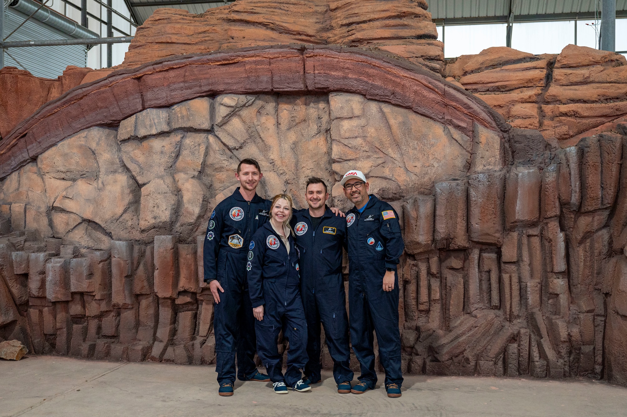 Wallace and his team stand in front of the backdrop of the Space Analog for the Moon and Mars