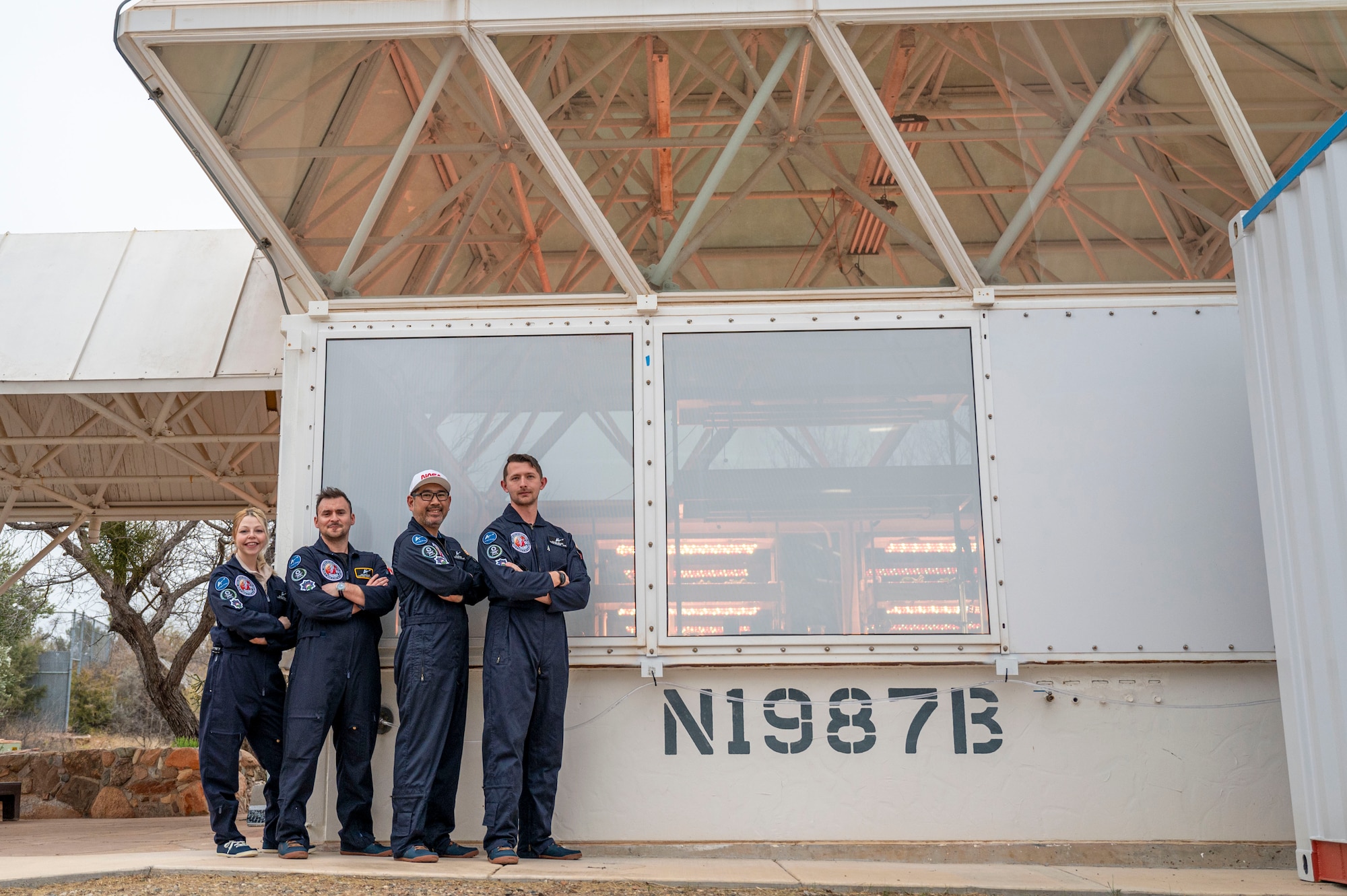Wallace and his team pose for a photo in front of the Space Analog for the Moon and Mars.