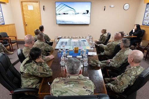 U.S. Air Force Brig. Gen. Lance French, Air Force Installation Contracting Center commander, center, and leaders of the 49th Contracting Squadron and 635th Materiel Maintenance Group watch a video about the Basic Expeditionary Airfield Resources base at Holloman Air Force Base, New Mexico, Feb. 25, 2025.