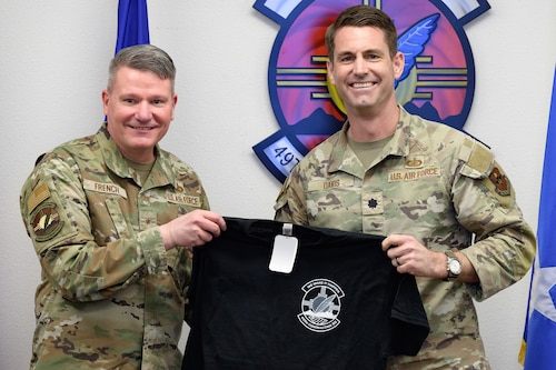 U.S. Air Force Brig. Gen. Lance French, Air Force Installation Contracting Center commander, left, receives a 49th Contracting Squadron shirt from U.S. Air Force Lt. Col. Alan Davis, 49th CONS commander at Holloman Air Force Base, New Mexico, Feb. 25, 2025
