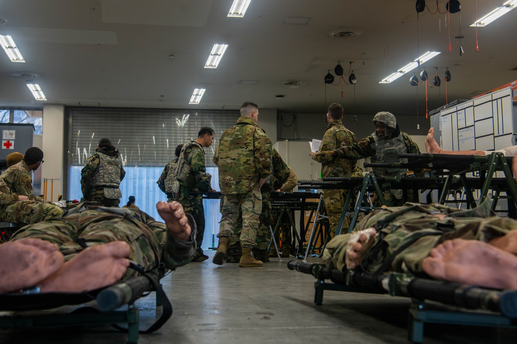 U.S. Air Force Airmen assigned to the 374th Medical Group assess and prepare simulated patients for transport.