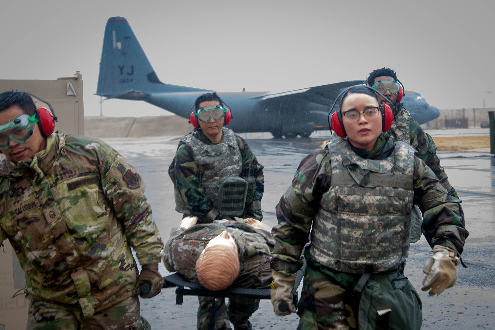 U.S. Air Force Airmen assigned to the 374th Medical Group transport simulated patients for an aeromedical evacuation.
