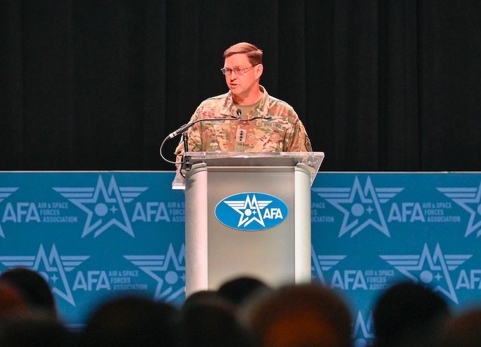 A military leader speaks at a podium.