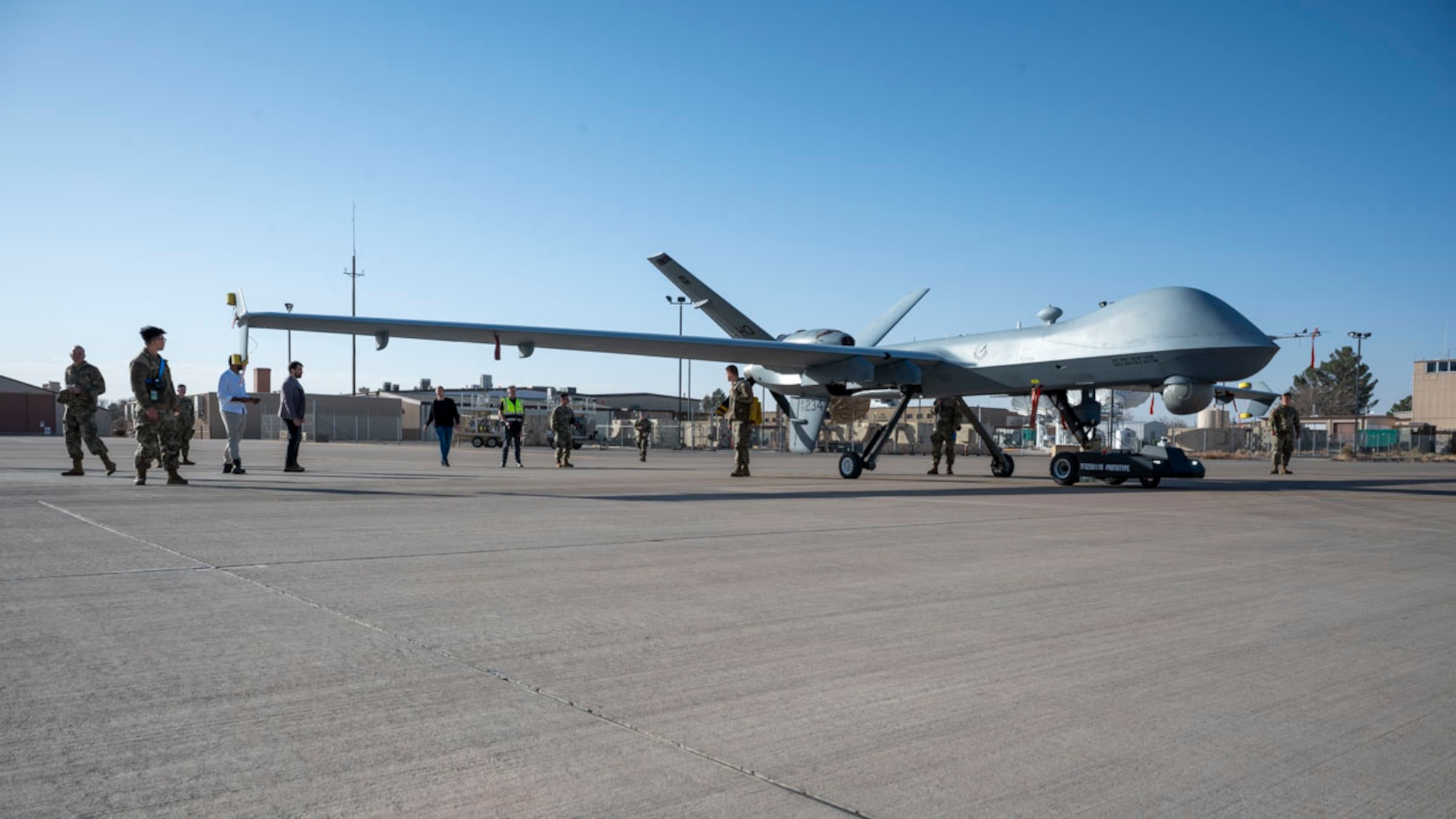 Members of Holloman, TowFLEXX Miltech and Evitado conduct an MQ-9 Reaper towing demonstration at Holloman Air Force Base, New Mexico, Feb. 27, 2025. The 49th Maintenance Group is enhancing mission readiness by partnering with Evitado Technologies and TowFLEXX Miltech to develop a cutting-edge anti-collision solution for aircraft towing, integrating sustainable, emissions-free technologies that align with the Department of Defense’s Green Procurement Program and improve operational safety. (U.S. Air Force photo by Senior Airman Isaiah Pedrazzini)