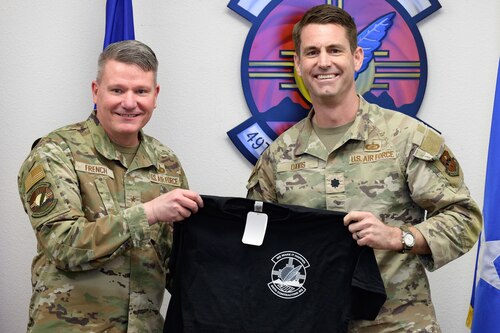 U.S. Air Force Brig. Gen. Lance French, Air Force Installation Contracting Center commander, left, receives a 49th Contracting Squadron shirt from U.S. Air Force Lt. Col. Alan Davis, 49th CONS commander at Holloman Air Force Base, New Mexico, Feb. 25, 2025