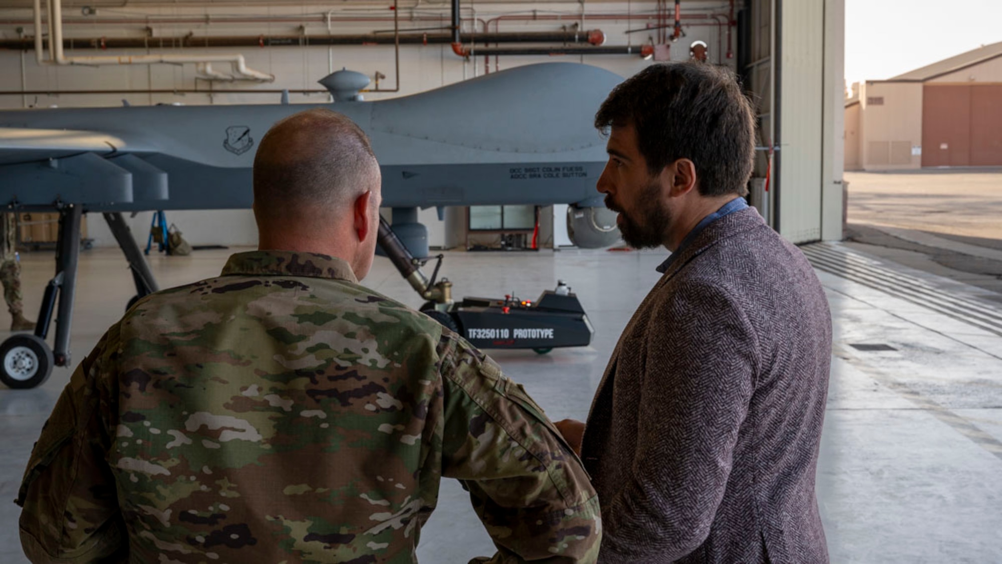 Alexander Kasinc, Evitado Technologies chief executive officer, right, conducts a towing demonstration to U.S. Air Force Col. Christopher Dunston, 49th Maintenance Group commander at Holloman Air Force Base, New Mexico, Feb. 27, 2025. Through a Phase II Small Business Innovation Research contract, the 49th Maintenance Group is working with Evitado Technologies and TowFLEXX Miltech to revolutionize aircraft towing with electric, remote-controlled tugs, while using advanced Light Detection and Ranging sensor technology to increase safety and efficiency, reduce manpower needs, and support sustainability goals for the Air Force. (U.S. Air Force photo by Senior Airman Isaiah Pedrazzini)