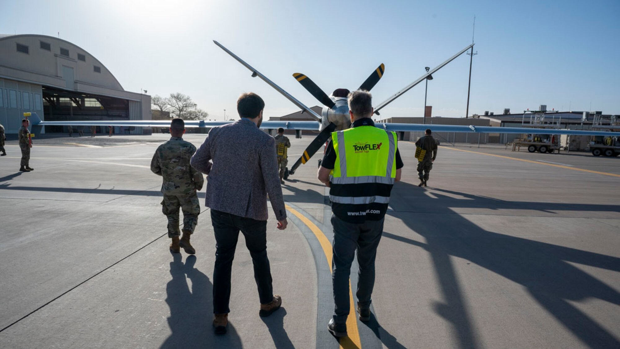 Members of Holloman, TowFLEXX Miltech and Evitado conduct an MQ-9 Reaper towing demonstration at Holloman Air Force Base, New Mexico, Feb. 27, 2025. The collaboration between the 49th Maintenance Group, Evitado Technologies, and TowFLEXX Miltech is to advance aircraft towing operations by integrating electric tugs with Light Detection and Ranging sensor collision detection, boosting safety, reducing costs, and supporting the U.S. Air Force’s sustainability and mission readiness objectives. (U.S. Air Force photo by Senior Airman Isaiah Pedrazzini)