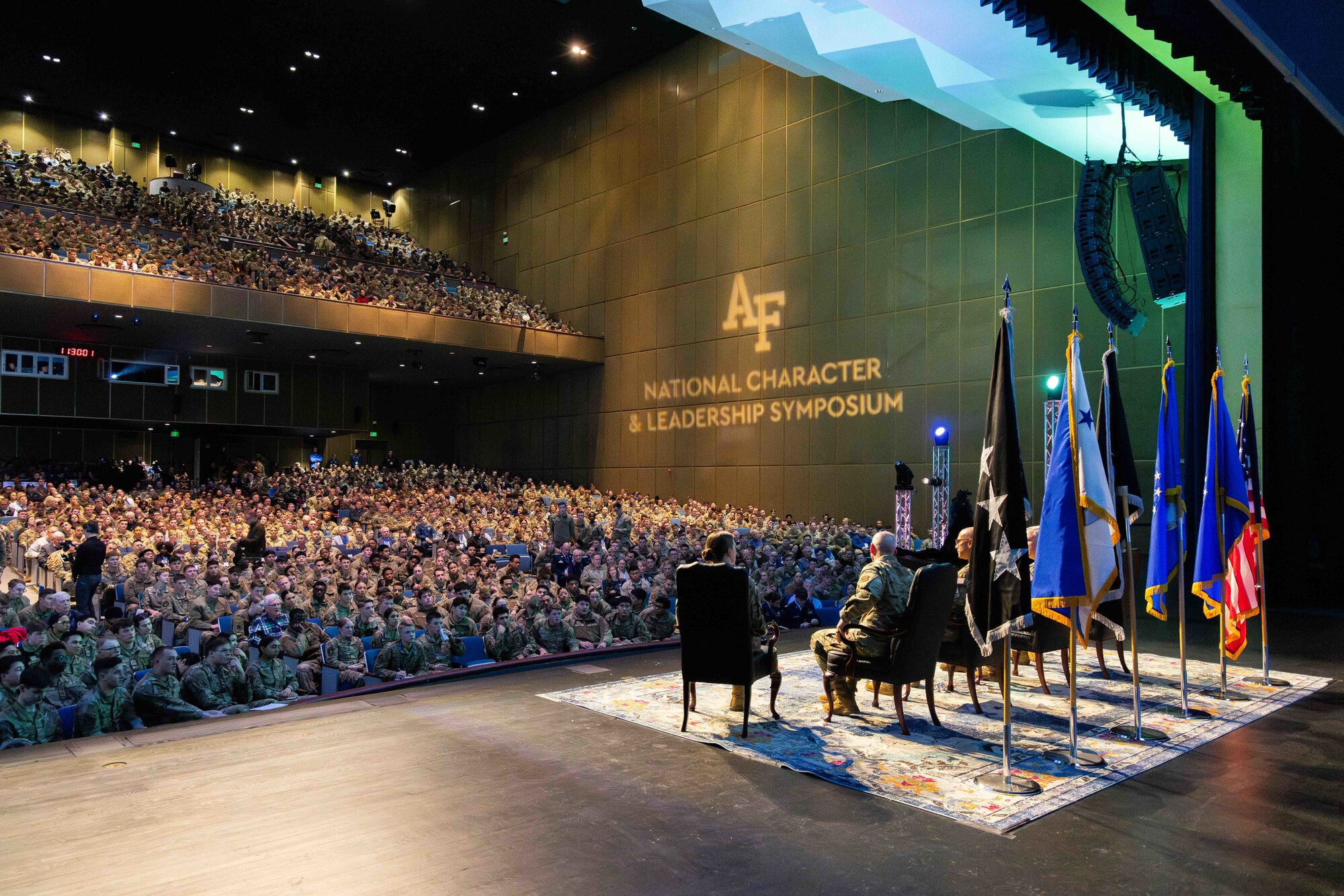 An audience of cadets, faculty, service members, visiting undergraduate students and community leaders listen to a senior leader panel during the National Character and Leadership Symposium