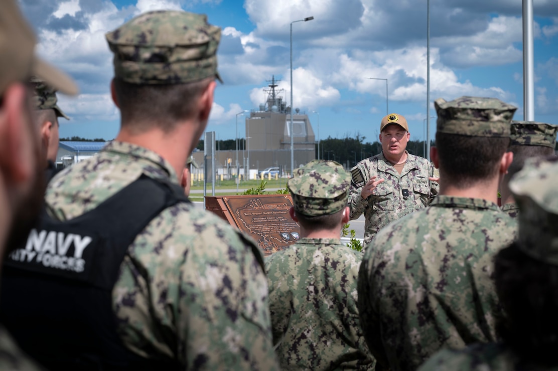 Rear Adm. Brad Collins, Commander, Navy Region Europe, Africa, Central discusses the operational necessity of Naval Support Facility (NSF) Redzikowo and the AEGIS Ashore Missile Defense System (AAMDS) with Sailors assigned to NSF Redzikowo, Aug. 7, 2024.