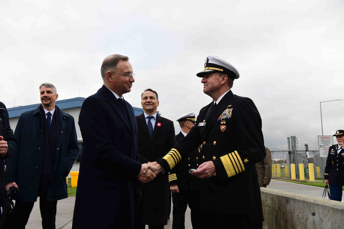 Adm. Stuart B. Munsch, commander, U.S. Naval Forces Europe-Africa (NAVEUR-NAVAF), right, and Polish President Andrzej Duda, left, shake hands after the ribbon cutting ceremony for the transfer of authority of the new Aegis Ashore Missile Defense System at Naval Support Facility Redzikowo, Poland, to NATO Nov. 13, 2024.