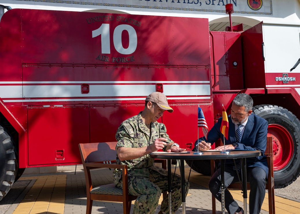 Capt. Teague Suarez, the commanding officer of Naval Station (NAVSTA) Rota, Spain, and José Javier Ruiz Arana, the Mayor of the City of Rota, sign a deed to gift a U.S. firetruck to the city of Rota's base forum onboard NAVSTA Rota, Spain, April 23, 2024.