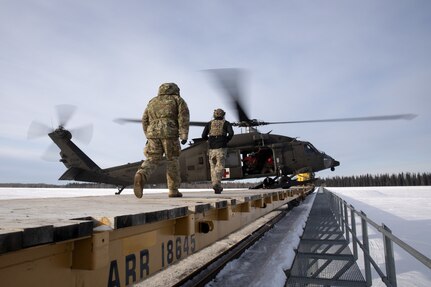An Alaska Army National Guard HH-60M Black Hawk helicopter assigned to Golf Company, 2-211th General Support Aviation Battalion, lands on an Alaska Railroad train car while supporting Special Operations Forces Arctic Medic 2025 near Fairbanks, Alaska, Feb. 20, 2025. Approximately 100 participants from SOF and Allied and Interagency partners trained to improve tactical and prolonged combat casualty care in austere conditions.