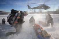 Special Operations Forces Arctic Medic 2025 participants shield themselves from the rotor wash of a departing U.S. Army UH-60L Black Hawk helicopter, assigned to Alpha Company, 1-52D General Support Aviation Battalion, during arctic medical training at Yukon Training Area, Fort Wainwright, Alaska, Feb. 19, 2025.