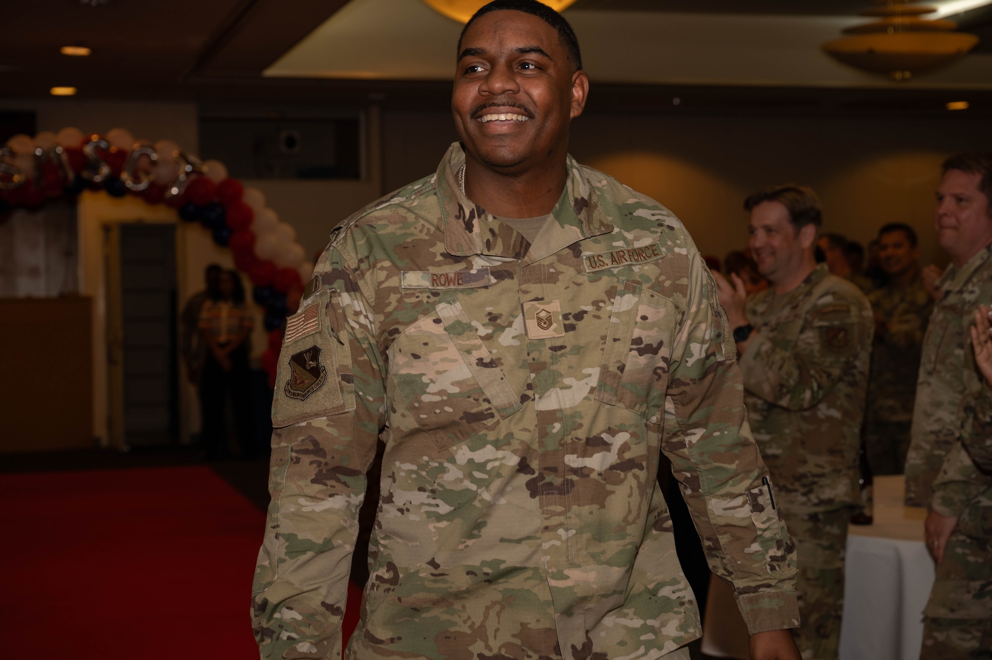 A service member walks down runway.