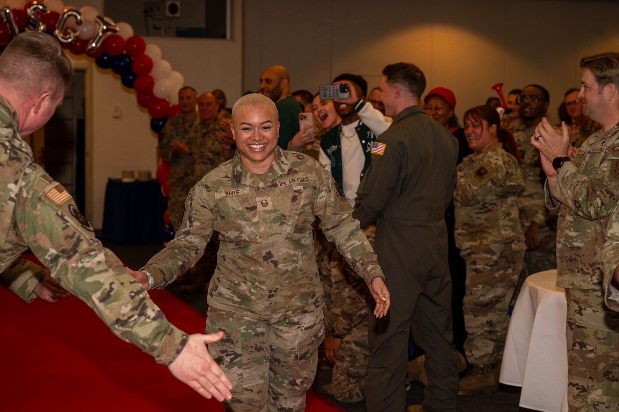 A service member walks down runway.
