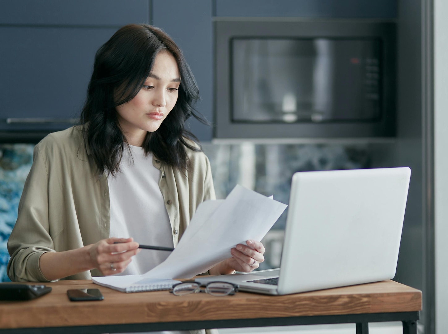 Woman looks at papers.