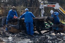 Tech. Sgt. Christopher Mathis (far right), 775th Civil Engineer Squadron, assists with clean up efforts in the aftermath of the California wildfires. Guzman spent two weeks primarily removing batteries from electric vehicles and burned residences with power walls for solar panels. (Courtesy Photo)
