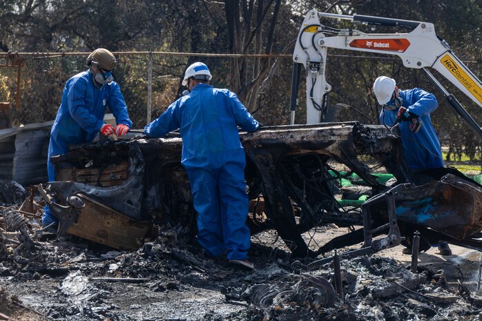 Tech. Sgt. Christopher Mathis (far right), 775th Civil Engineer Squadron, assists with clean up efforts in the aftermath of the California wildfires. Guzman spent two weeks primarily removing batteries from electric vehicles and burned residences with power walls for solar panels. (Courtesy Photo)